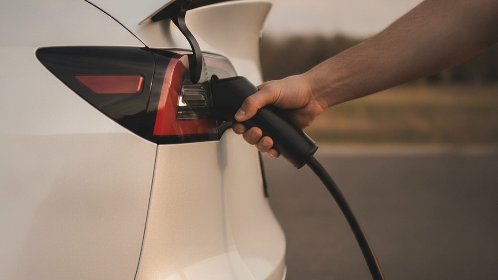 Close-up of an EV charge cable still locked in a car charge port